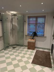 a bathroom with a shower and a tile floor at Kanalhuset in Motala +23 photos