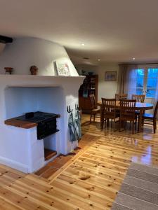 a living room with a fireplace and a table and chairs at Kanalhuset in Motala