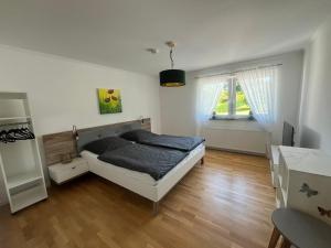 a bedroom with a bed in the middle of a room at Ferienwohnung Auszeit Langsur in Langsur +17 photos