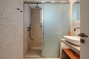 a bathroom with a shower and a sink at Ammolofos Luxury Apartment & suites in Naxos Chora +49 photos