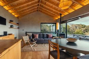 a living room with a table and a couch at Casa da Figueira in São Roque do Pico
