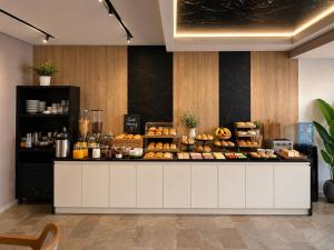 a bakery with a display of food on a counter at Hotel Mare in Ksamil
