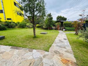 a garden with a tree and a stone walkway at Sakai Garden and Villa in Sakai +62 photos