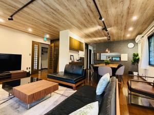 a living room with a couch and a table at Sakai Garden and Villa in Sakai