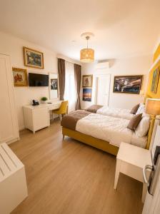 a bedroom with a large bed and a desk at ART Hotel Tirana in Tirana