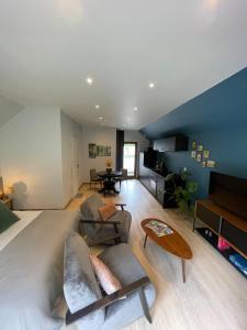 a living room with a couch and a table at Ecrin de Vizaille in Toucy
