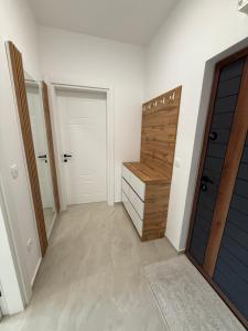 a hallway with a wooden door and a closet at Sea Sand Apartment in Bijela Glavica +4 photos