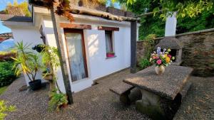 a house with a table with a vase of flowers on it at Ca'Neggio in Neggio