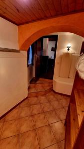 a hallway in a house with a tile floor at Ca'Neggio in Neggio