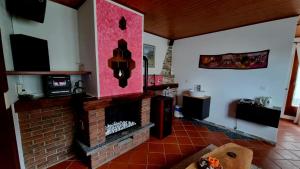 a living room with a brick fire place at Ca'Neggio in Neggio +2 photos