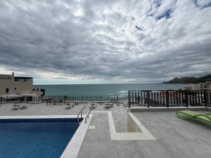 a swimming pool with a view of the ocean at Sea Sand Apartment in Bijela Glavica