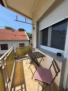 two chairs and a table on a balcony at Apartman "WALKOW", SELF CHECK IN, FREE PARKING in Vukovar