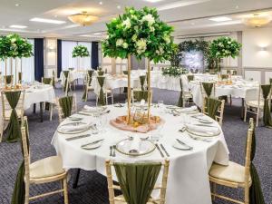a banquet room with white tables and chairs at Mercure Nottingham Sherwood in Nottingham +107 photos