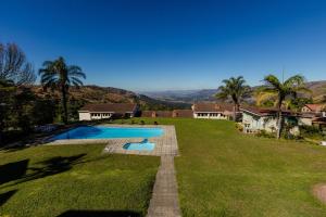 a large yard with a swimming pool and a house at Mountain View International Hotel - Eswatini in Mbabane +69 photos