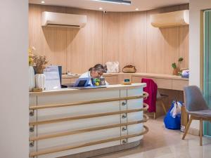 a woman sitting at a desk in an office at The Terraza Condotel in Nathon Bay +242 photos