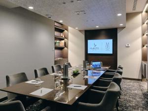 a conference room with a long table and chairs at Manto Hotel Lima - MGallery Collection in Lima +221 photos