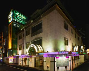 a building on a street at night with neon lights at HotelG7 in Tokyo