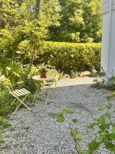 a small table and a chair in a garden at The lighthouse in St Ives +5 photos