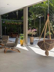 a patio with chairs and a hammock in a building at Golden Ville Hotel in Marabá