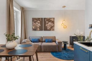 a living room with a couch and a table at dreamfactory Residence - Royal Westside in Vienna