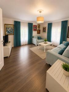 a living room with a couch and a table at ART Hotel Tirana in Tirana