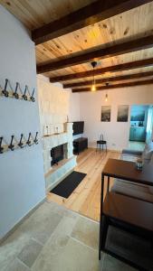 a living room with a fireplace and a table at Casa dintre munti in Bozioru