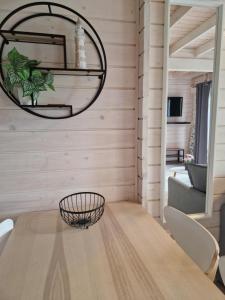 a dining room with a wooden table and a mirror at LABALAND in Gąski