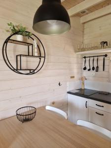 a kitchen with a round mirror and a sink at LABALAND in Gąski +20 photos