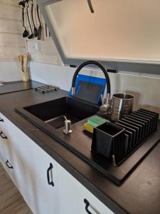 a kitchen counter with a sink in a kitchen at LABALAND in Gąski