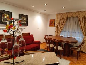 a living room with a table and a red couch at Casa Diego in Muñón Fondero +7 photos