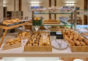 a bakery with many different types of pastries on display at Hotel Murillo Reinoso in Seville