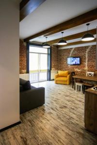 a living room with a couch and a pool table at Potocki Apartments in Lviv