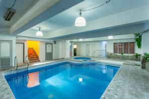 a large pool with blue water in a house at Yahweh's Spring Retreat and Resort in Calamba