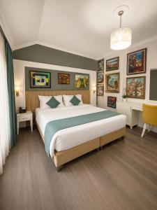 a bedroom with a large bed in a room at ART Hotel Tirana in Tirana