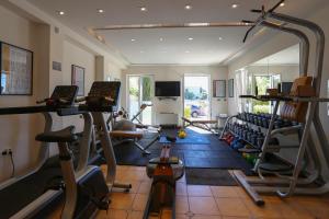 a gym with several tread machines and a mirror at Villa Hresc M in Zadar