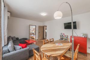 a living room with a table and a couch at Orličky Apartments in Orličky