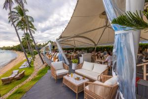 a restaurant on the beach with chairs and tables at Replay Studio near Beach in Bangrak Beach