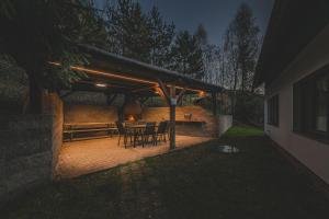 a patio with a table and chairs under a roof at Orličky Apartments in Orličky +58 photos