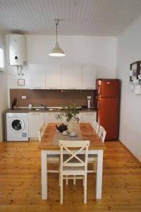 a kitchen with a wooden table with chairs and a refrigerator at TT Apartmani - Historic Center Pula in Pula