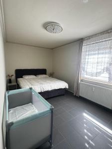 a bedroom with a bed and a window at Das gemütliche Unterkunft in Gelsenkirchen