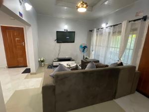 a living room with a couch and a flat screen tv at Elimisam stays in Kitwe