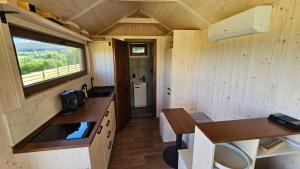 an interior view of a kitchen in a tiny house at Glamping Šumava in Hartmanice
