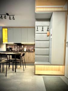 a kitchen and dining room with a table and chairs at InGalaxy Green Apartment in Szczecin +6 photos