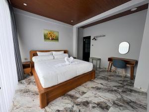 a bedroom with a bed and a desk in it at Tera Bali Villa 3 Bedugul in Bedugul