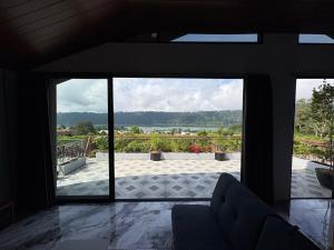 a room with a large glass door looking out onto a patio at Tera Bali Villa 3 Bedugul in Bedugul