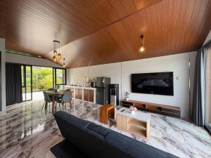 a living room with a couch and a table at Tera Bali Villa 3 Bedugul in Bedugul