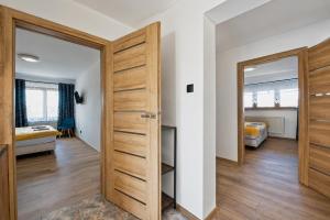 a room with a door leading to a bedroom at Apartament pod gruszą in Legbąd +2 photos