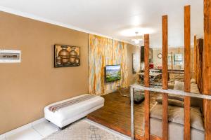 a living room with a couch and a table at Swallows Nest Haven in Boksburg