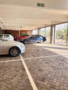 a group of cars parked in a parking lot at Casa Stays in Kiambu
