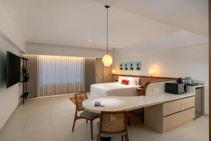 a hotel room with a bed and a desk at Greenpark Chennai in Chennai